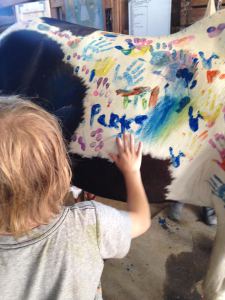 Parks painting a horse at camp.